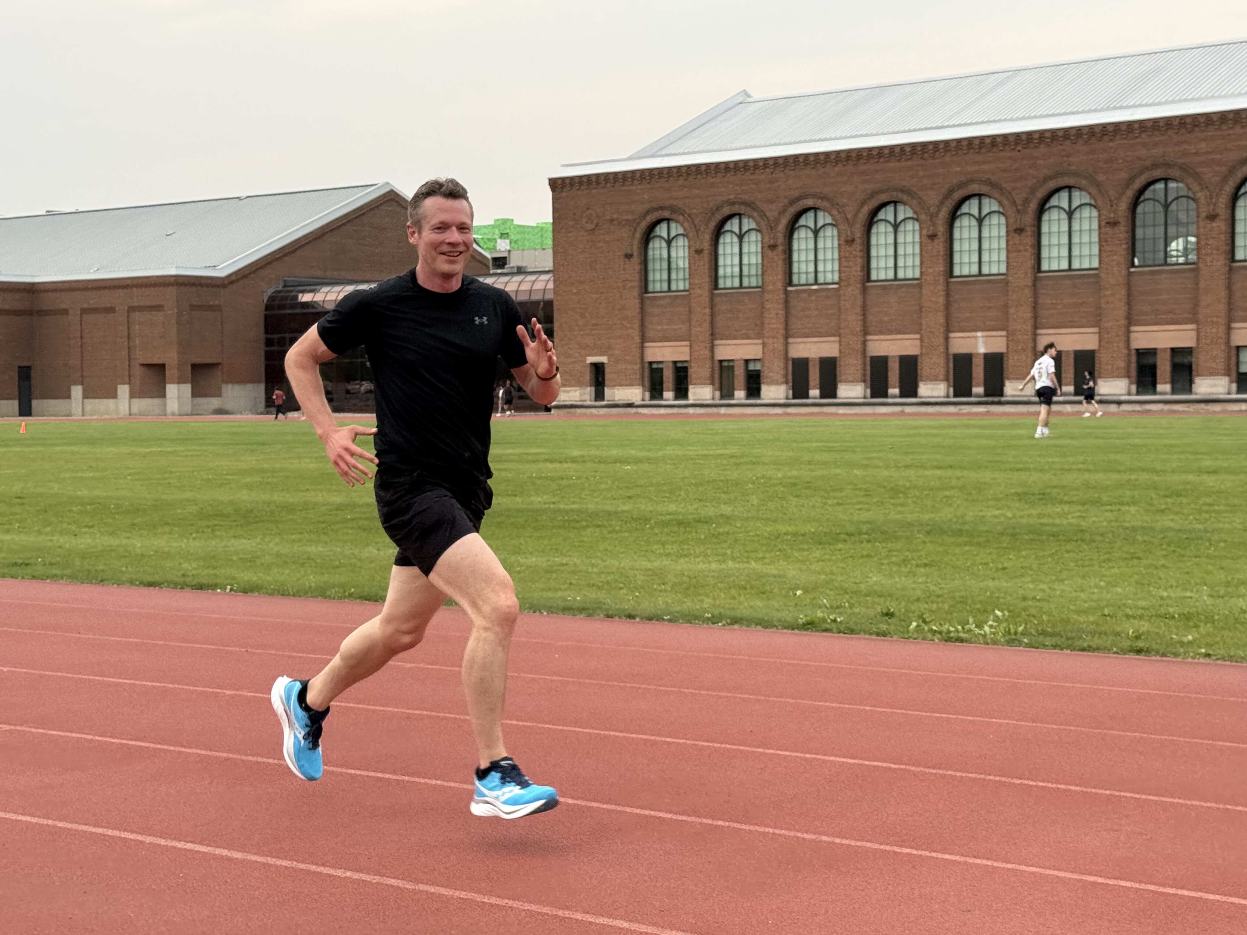 Chris Schults running on a track
